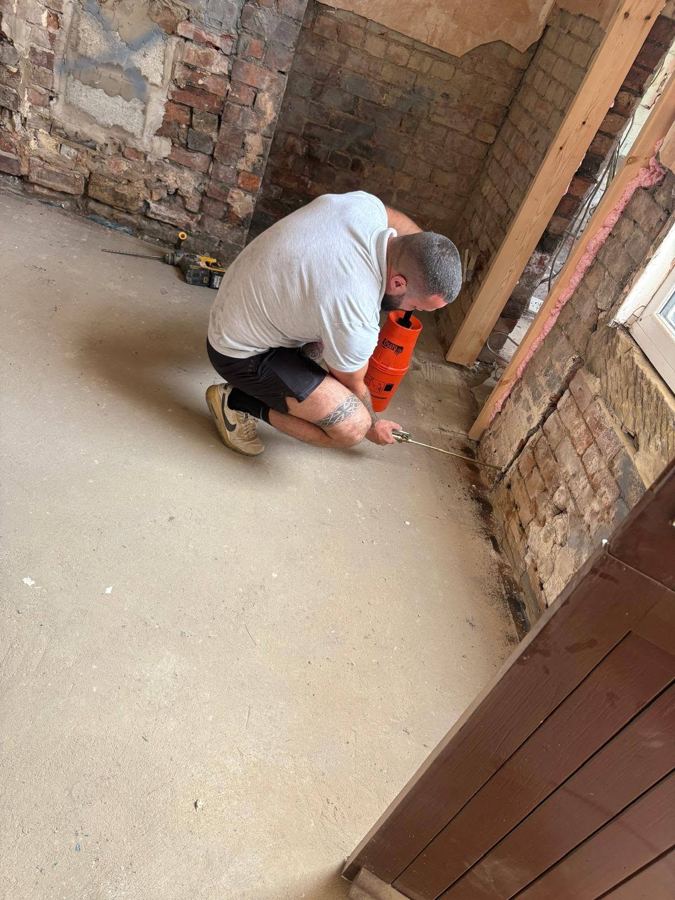 E&H technician preparing a wall for damp proof course injection