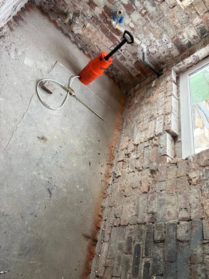 Chemical damp proof course injection in progress